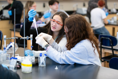 Two teenaged girls taking part in the Amgen Biotech Experience